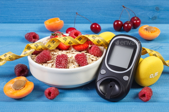 Glucose meter, fresh oatmeal with fruits, centimeter and dumbbells, concept of checking sugar level - Stock Photo - Images