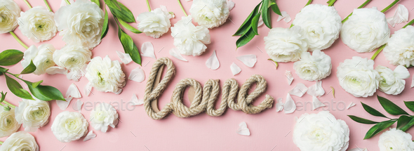 Saint Valentines Day background with ranunculus flowers and word love Stock Photo by sonyakamoz