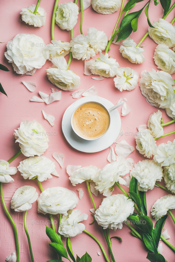 Flat-lay of cup of coffee surrounded with white ranunculus flowers - Stock Photo - Images