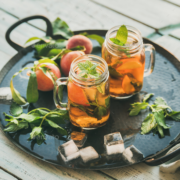 Summer refreshing cold peach ice tea on tray, square crop - Stock Photo - Images