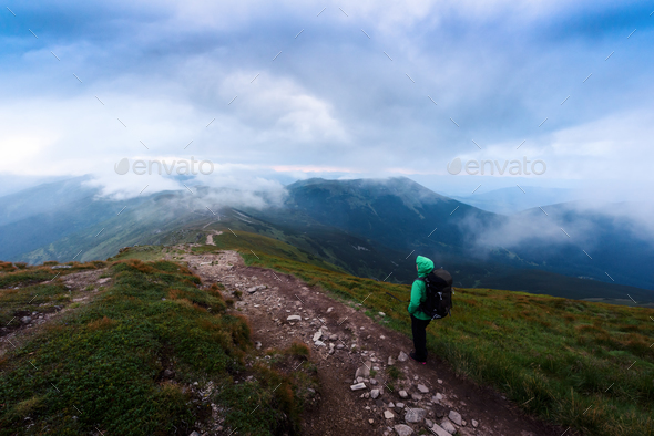 Alone tourist staying on the edge of the cliff - Stock Photo - Images