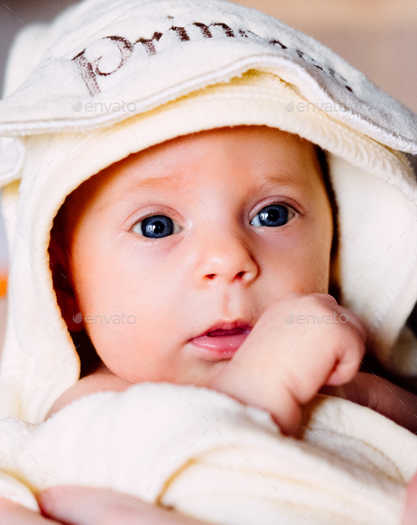 Cute happy little baby girl in soft towel after bath. Happy family concept Stock Photo by Determined