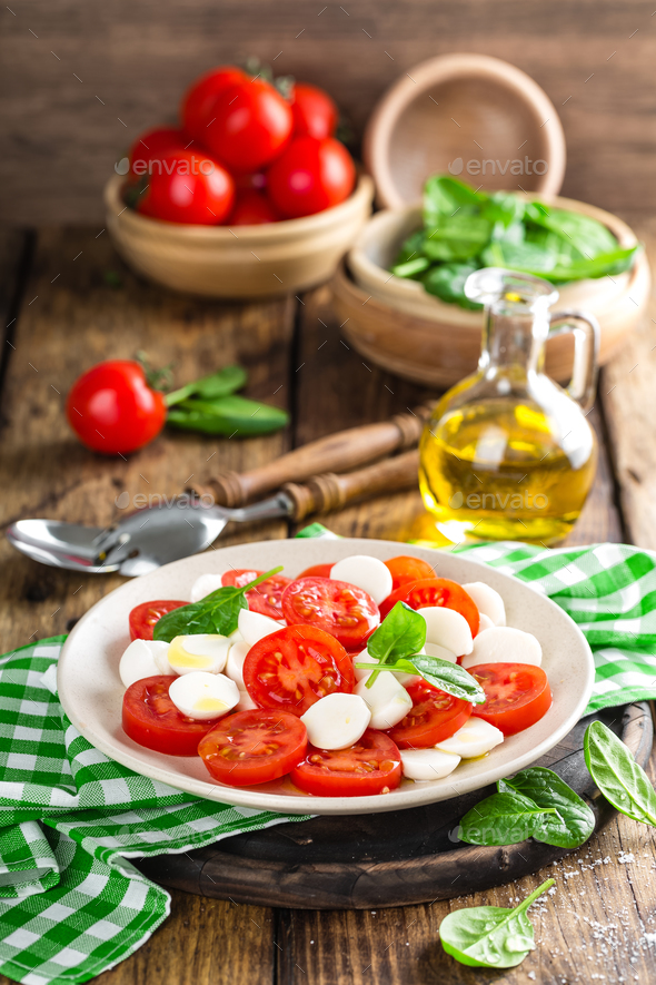 Tomato salad with mozzarella cheese and olive oil Stock Photo by sea_wave