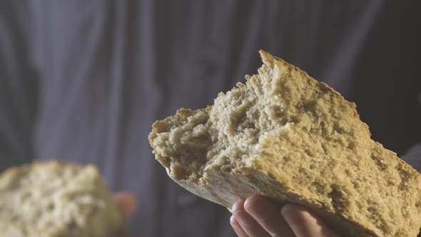 Baker Hands Breaking Homemade Bread and Give You.  View