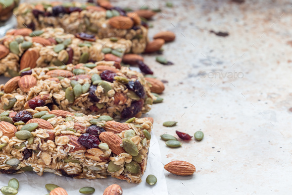 Homemade granola energy bars with figs, oatmeal, almond, dry cranberry and pumpkin seeds - Stock Photo - Images