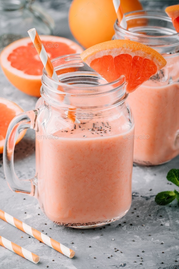 healthy detox smoothie in mason jar of red grapefruit with banana and chia seeds Stock Photo by nblxer