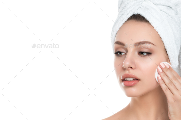 Portrait of young beautiful woman cleaning her face - Stock Photo - Images