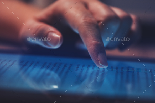 Extreme close up of female finger using digital tablet computer - Stock Photo - Images