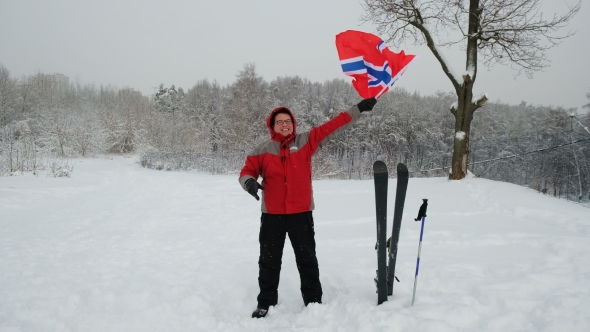 Happy Man Sport Fan Waving Flag of Norway Outdoors