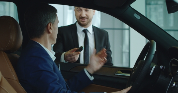 Sales Manager Gives Key To Customer alt