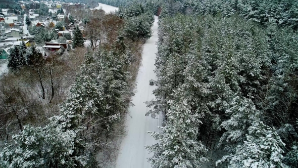 Aerial View of Car Moving in Winter Forest