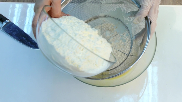 The Cook Sifts the Flour Through a Sieve