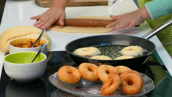 The Cook Rolls Out the Dough and Fry Donuts