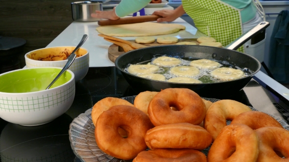 The Cook Rolls out the Dough and Fry Donuts