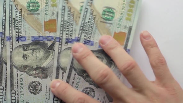 Man's Hand Shows New Us Dollar Banknotes on White Background