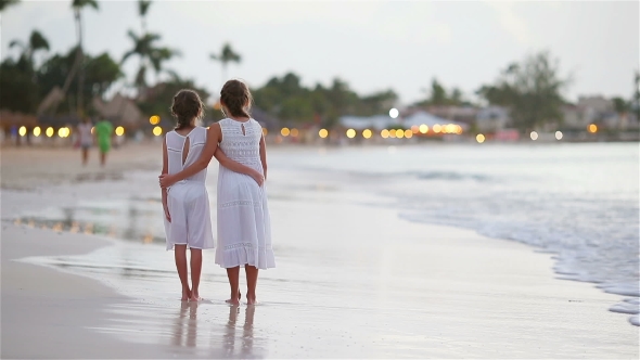 Adorable Little Kids Walking on the Beach with Beautiful Colorful Sunset alt