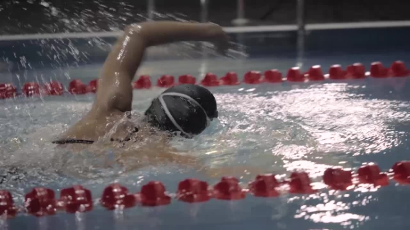 Female Professional Swimmer Turning Underwater on Swimming Pool alt
