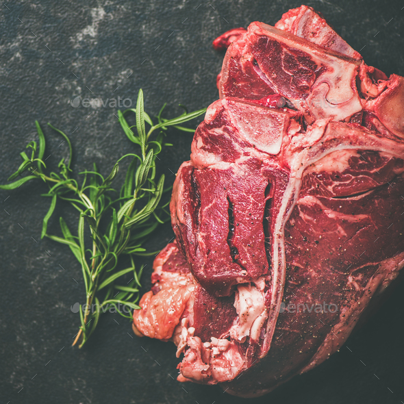 Fresh raw beef meat t-bone steaks with rosemary, square crop - Stock Photo - Images