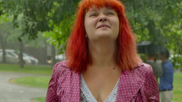 Red-haired Girl Becomes Wet Under the Rain.