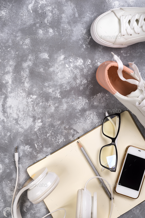 Summer holiday concept: smartphone , white sneakers, notepad, headphones, pen - Stock Photo - Images