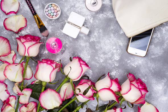Bouquet of roses with cosmetics in perfume on a gray background with copy space - Stock Photo - Images