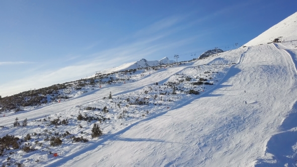 Skiers on Ski Slope in High Tatras Mountains Aerial. alt