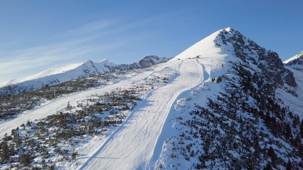 Skiers on Ski Slope in High Tatras Mountains Aerial. alt