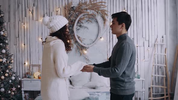 Young Couple, Boy and Girl Holding Hands at Home in the Living Room and Spending Comfortable Time alt