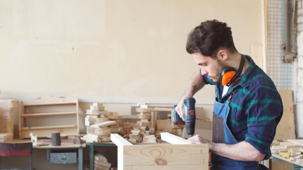 Wood Boring Drill in Hand Drilling Hole in Wooden Bar.