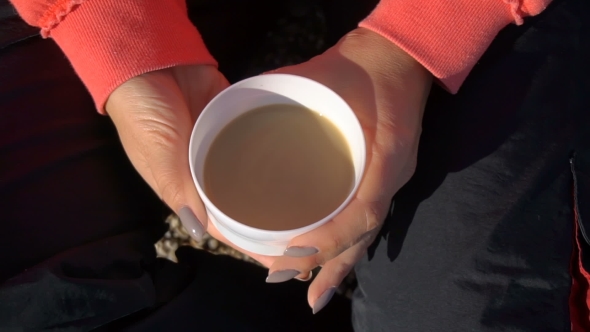 Girl Holding Mug with Coffee at the Beach.