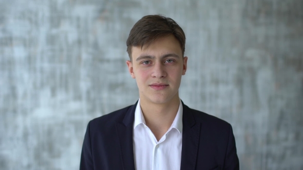 Young Man or Male Student Nods and Shows Thumbs Up. Man Agree with the Idea of and Gives Thumbs Up