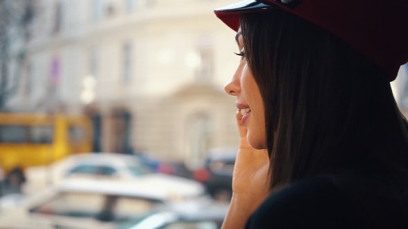 Happy Woman Talks on the Phone Sitting in a Cosy Cafe in Cold Winter Day alt