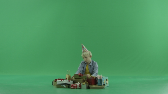 Little Boy Opens Christmas Present, Green Chroma Key Background