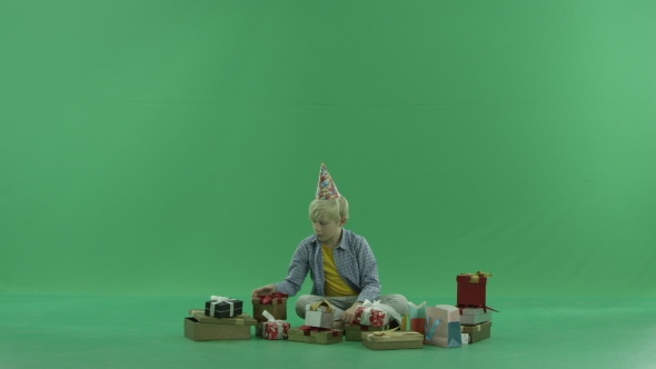 Little Boy Looks for Christmas Present, Green Chroma Key Background