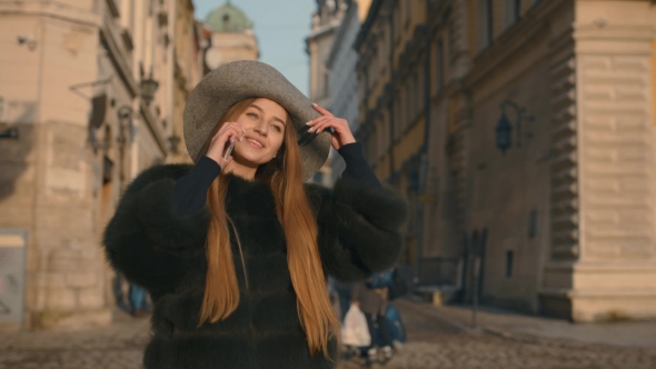 Young Girl Calling Somebody on the Phone, Talking and Smiling Happily alt