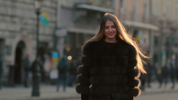Charming Girl with Big Blue Eyes and Stylish Look Turns To Camera and Smiles alt