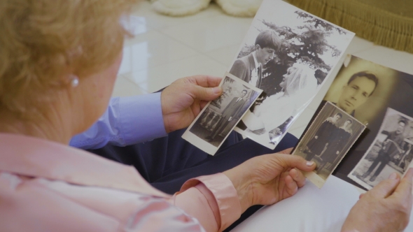Senior Couple Looks Photos of Their Youth alt
