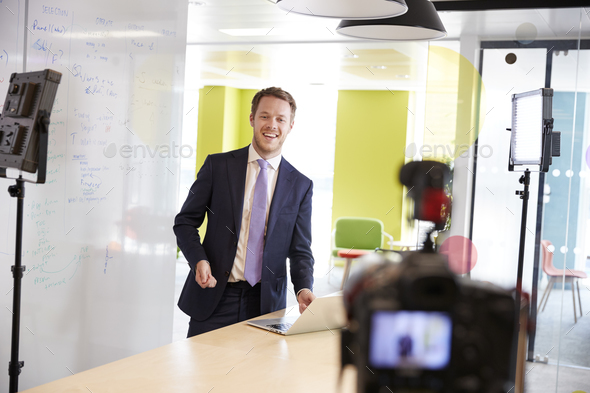 Young white man making a corporate demonstration video Stock Photo by monkeybusiness