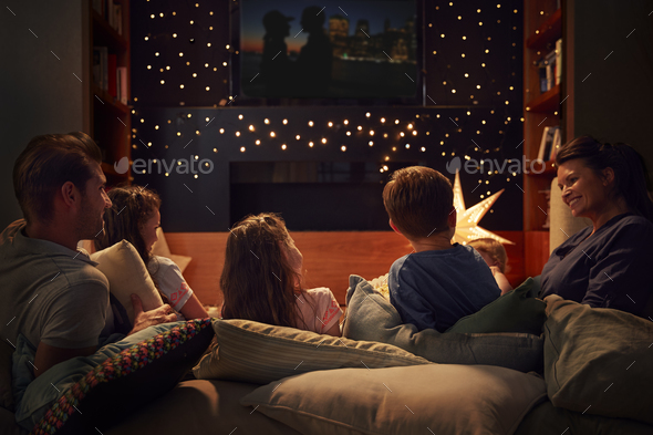 Family Enjoying Movie Night At Home Together Stock Photo by monkeybusiness