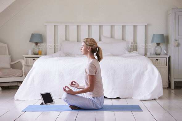 Woman With Digital Tablet Using Meditation App In Bedroom - Stock Photo - Images