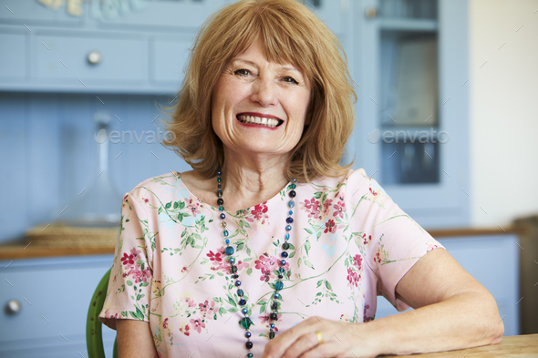 Portrait Of Smiling Senior Woman At Home Sitting At Table - Stock Photo - Images