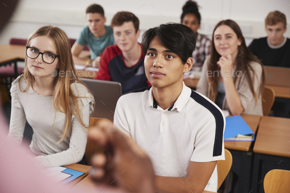 College Students In Class Viewed From Behind Teacher Stock Photo by monkeybusiness