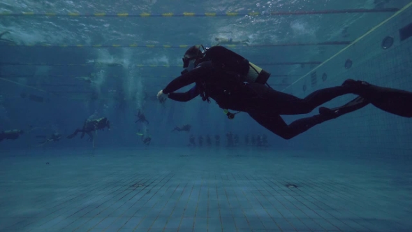 Scuba Diver Floating Underwater in Swimming Pool. Learning Scuba Diving Course alt