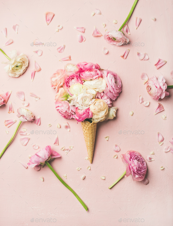 Waffle cone with pink and white buttercup flowers - Stock Photo - Images