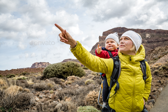 Super Mom with baby boy hiking in backpack - Stock Photo - Images