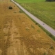 Flying Over Asphalt Road Between Farm Fields in Countryside - VideoHive Item for Sale