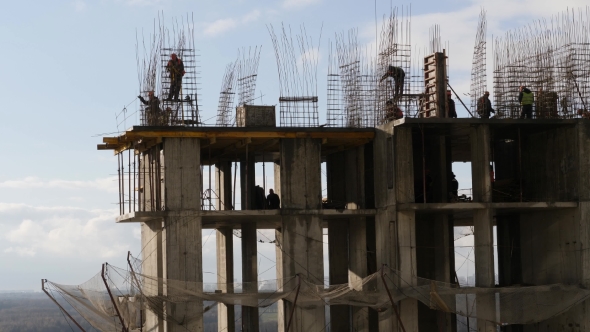 Workers at Construction Site Make Metal Reinforcements for Ferro-concrete Framework alt