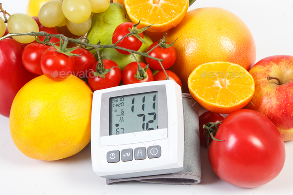 Blood pressure monitor and fresh ripe fruits with vegetables, healthy lifestyle and nutrition - Stock Photo - Images