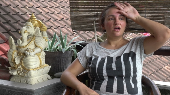 Sweaty Woman Feeling Hot Sitting at Balcony in Hot Asian Climate