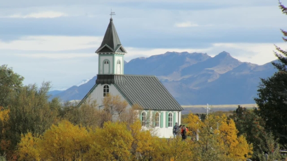 Old Traditional Icelandic Building in a Park in Autumn Day in Background of Mountain